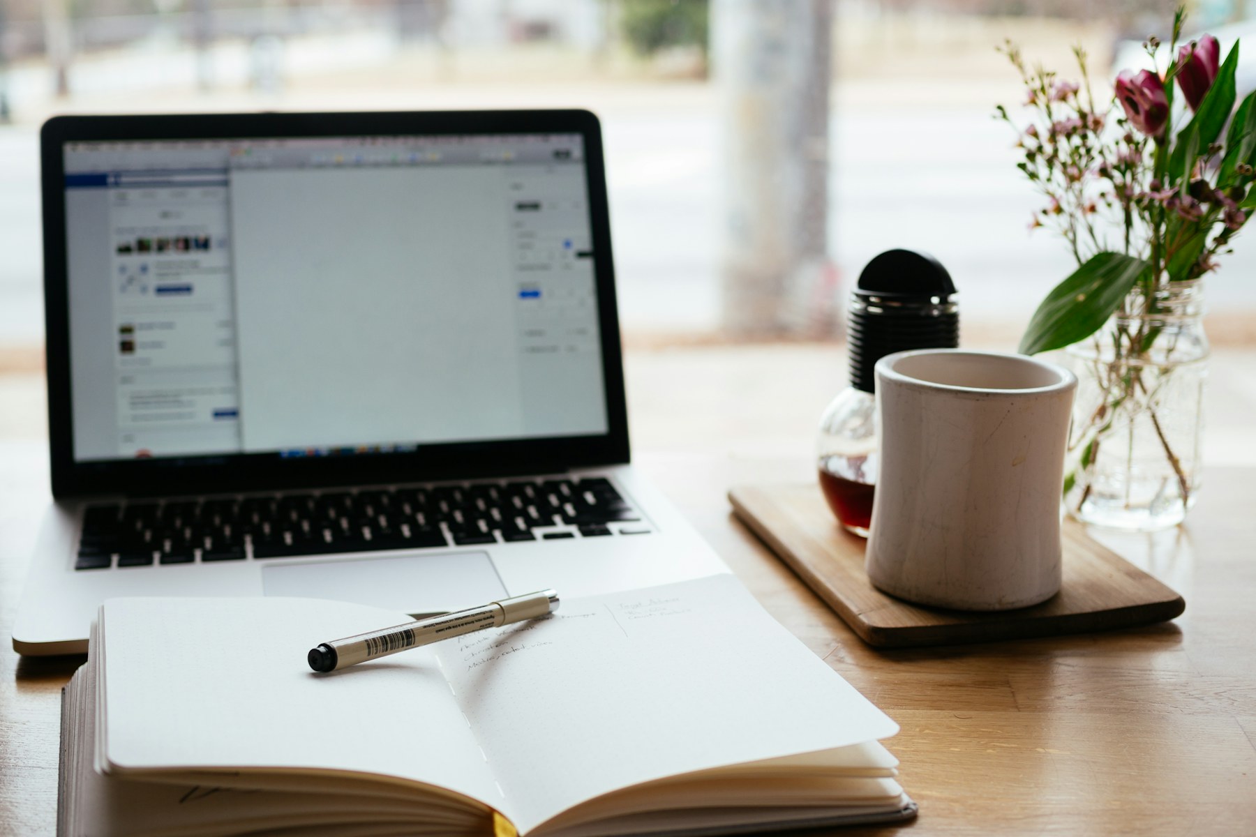 Professional workspace with a laptop and planning notes